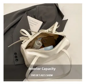 Spacious interior of retro underarm pillow bag with bow detail showing ample storage capacity