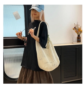 Detail of white cotton rope woven tote bag with hollow out crochet mesh design