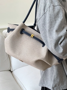 Minimalist canvas tote bag with navy leather trim for women commuting in style