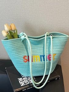 Light blue woven beach tote bag with colorful summer embroidery and floral decor