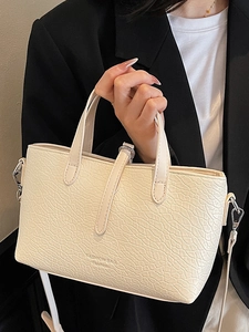 Vintage pebble textured cream crossbody bucket bag with elegant silver hardware handle