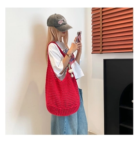 Detail view of the red cotton crochet tote bag with hollow woven mesh for beach use