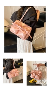 Detail view of pink glossy PU tote bag featuring large stylish double bows