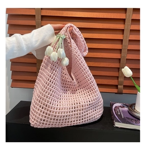 Detailed shot of pink crochet tote bag featuring white 3D tulip pendant decorations