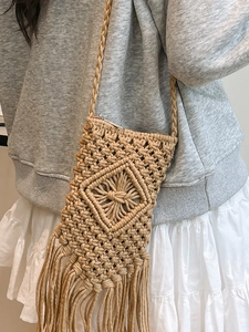 Handmade crochet crossbody bag with diamond pattern and tassel fringe for summer beach wear
