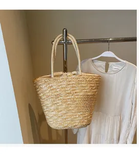 Detail of woven straw handbag featuring high-quality natural fiber and secure drawstring liner