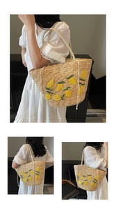 Close-up of woven straw tote bag featuring detailed 3D yellow lemon embroidery accents