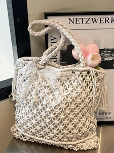Handwoven cream cotton mesh handbag with lace bow and pearl charms for beach vacations