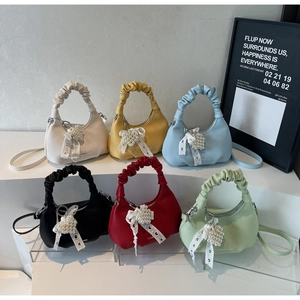 Mini pleated crossbody handbags in multiple colors featuring pearl heart ribbon charms