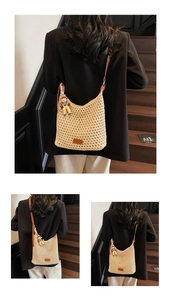 Detail of beige woven bucket bag with brown leather strap and cute boy doll charm