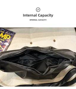 Macro view of black leather hobo bag showing spacious interior with multiple pockets