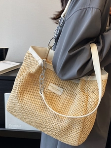 Large straw tote bag with white leather trim and silver metal chain handle for summer fashion