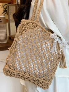 Handmade woven tote bag with fringe and pearl charms for summer beach vacations