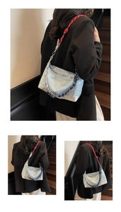 Three-way view of a denim handbag with red woven rope strap and silver chain detail