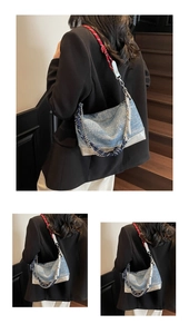 Detail of crescent denim shoulder bag with woven rope strap and metallic silver paneling