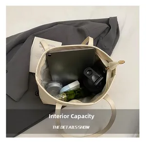 Detail showing high-capacity interior of beige tote bag with tablet and daily essentials