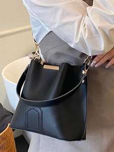 Minimalist black faux leather bucket bag with gold hardware and dual shoulder straps