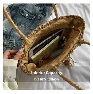 Detail view of large straw tote bag interior capacity with tablet and books inside