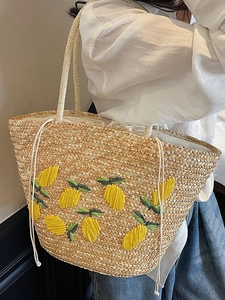 Summer straw tote bag with yellow lemon embroidery and secure drawstring closure