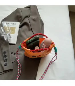 Top view of orange bucket bag interior showing capacity for phone and umbrella