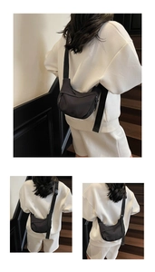 Detail of minimalist black nylon crossbody bag with adjustable strap and metal zipper