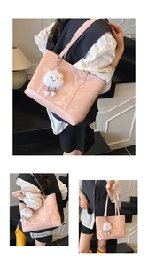 Pink patent leather tote bag detail with a cute white cloud plush charm accessory