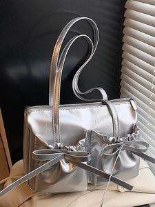 Silver bow shoulder bag in metallic leather with pleated pockets and long straps