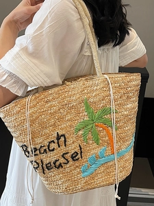 Embroidered straw tote bag with palm tree and Beach Please text on female shoulder