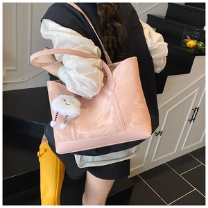 Pink marble texture tote bag with a white plush cloud charm shown in a lifestyle setting