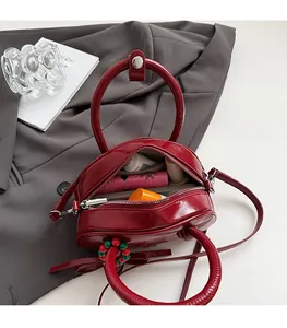 Interior view of red patent leather bowling bag showing space for lipstick and wallet