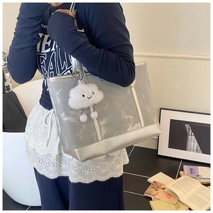 Silver-grey tote bag with plush cloud charm shown on model for casual everyday style