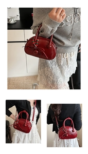 Detailed view of red bowling bag featuring bow tie decor and colorful bead charms