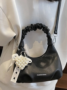 Mini black leather pleated handbag with pearl heart charm and crossbody strap