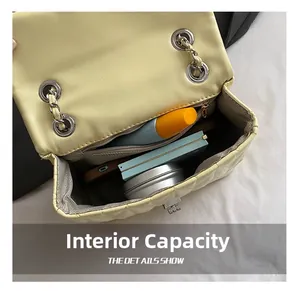 Internal capacity of yellow quilted chain bag showing space for phone and makeup