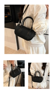 Detailed view of black pleated PU leather crossbody bag with adjustable strap and handles