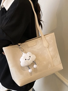 Minimalist beige shoulder tote bag with cute cloud charm and structured leather finish