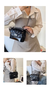 Three-way view of a black quilted shoulder bag with silver hardware and chain strap