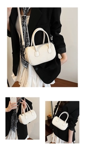 Detailed views of a white mini cylindrical crossbody bag with vertical pleated texture
