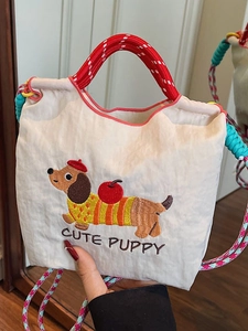 Beige bucket bag featuring cute dachshund embroidery and colorful woven straps