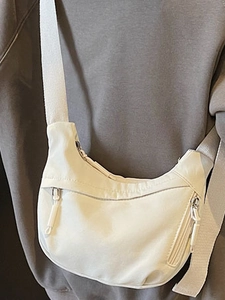 Minimalist off-white nylon crescent crossbody bag with multi-zipper pockets for women
