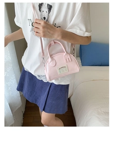 Détail du sac cabas rose en cuir PU avec étiquette en tissu dans un décor intérieur