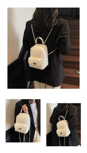 Three-way style view of cream quilted mini backpack with chain straps and top handle