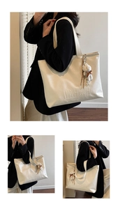 Detail of off-white tote bag with H.SHANMA embossing and cute plush bear charm