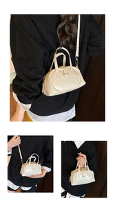 Detail view of cream white heart-shaped crossbody bag with soft faux leather texture