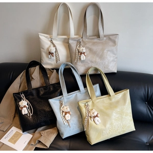 Detailed collection of colorful tote bags with H.SHAN embossing and cute bear charms