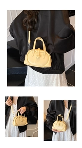 Detail of a bright yellow heart-shaped PU leather handbag with detachable shoulder strap
