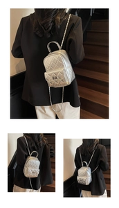 Silver metallic mini backpack featuring quilted diamond pattern and chain straps