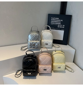 Detail view of mini quilted backpacks in silver, white, black, pink and yellow with chain straps
