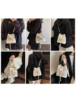 Multi-angle view of a plaid bucket bag with cartoon bear print and plush pendant
