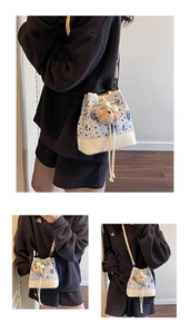 Detail of striped college style bucket bag with cute bear charm and leather bottom